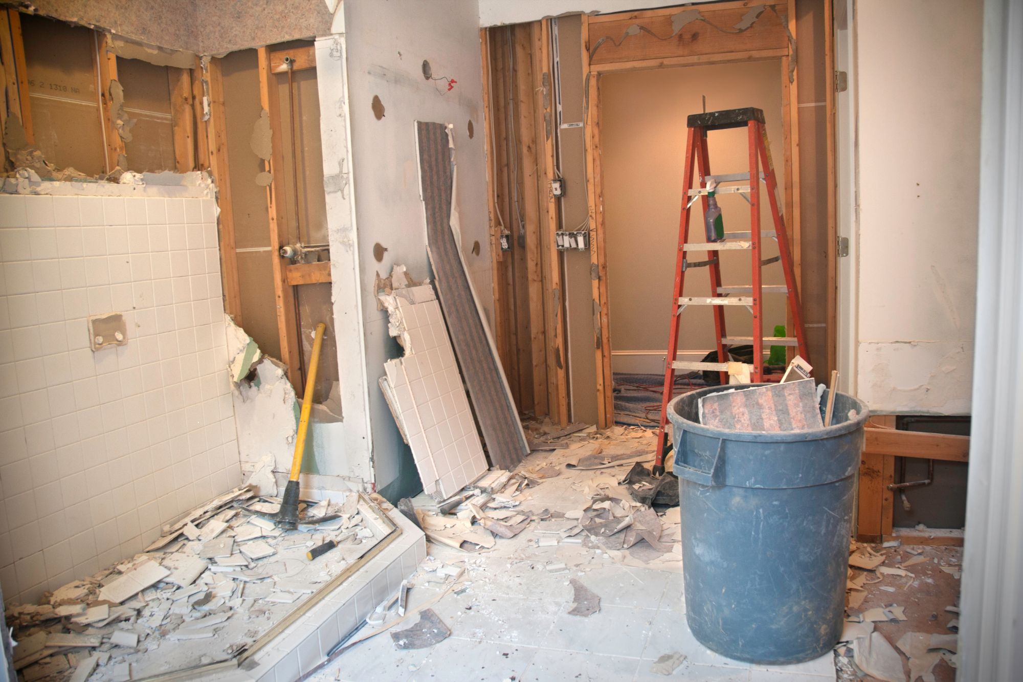 A bathroom scene with a ladder and a bucket, representing demolition and tear down services in Columbia, SC.