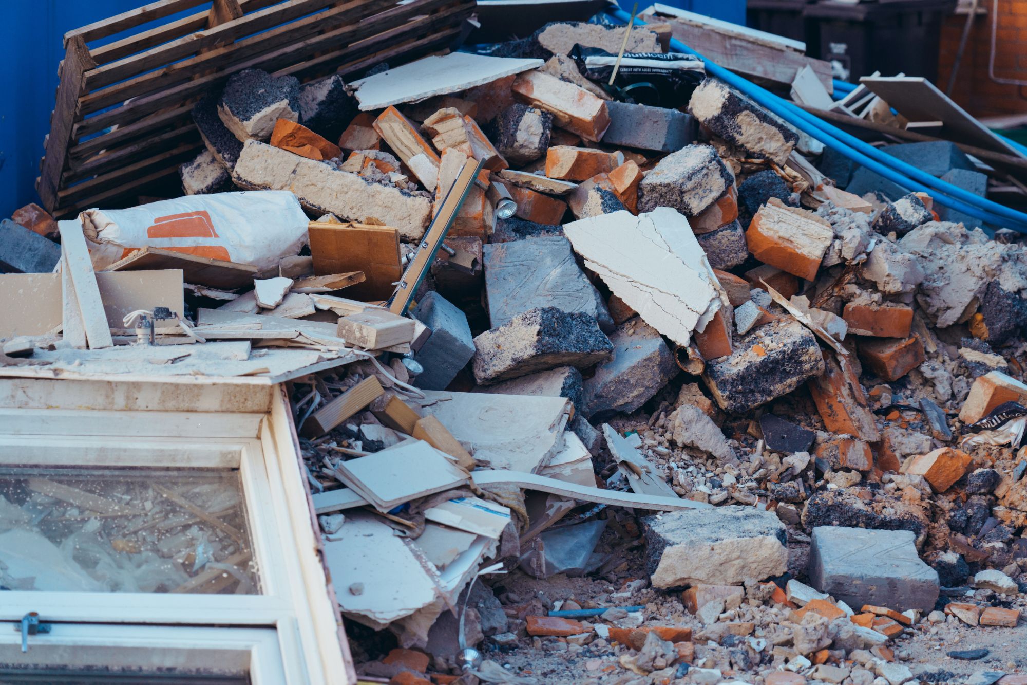 Debris and rubble stacked in front of a building, showcasing construction and renovation efforts in Columbia, SC.